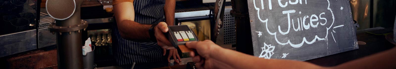 Person making payment in cafe.